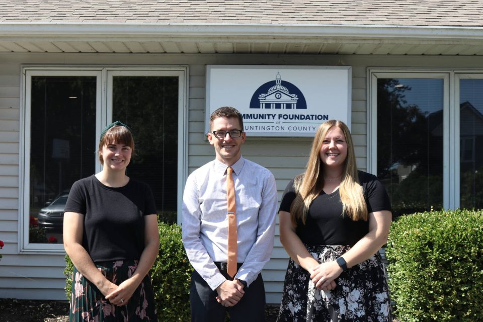 Three staff members pose in front of the Community Foundation Office